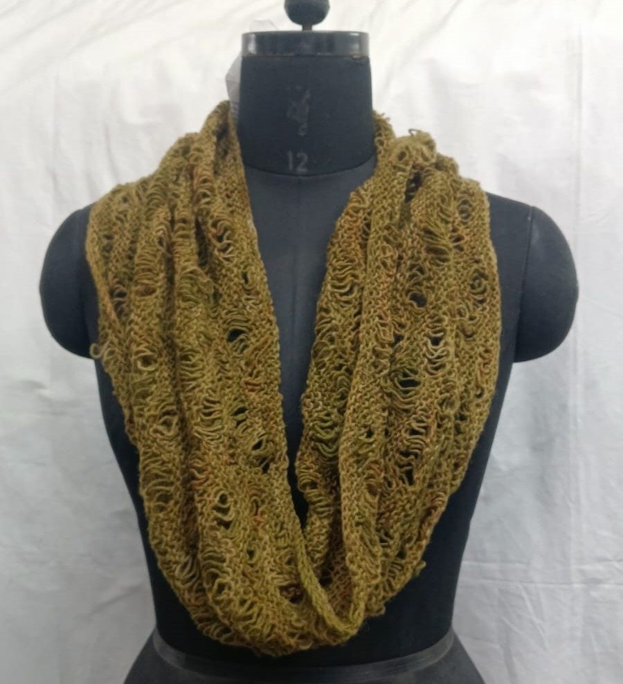 Handmade olive infinity scarf with open-knit design displayed on a mannequin.